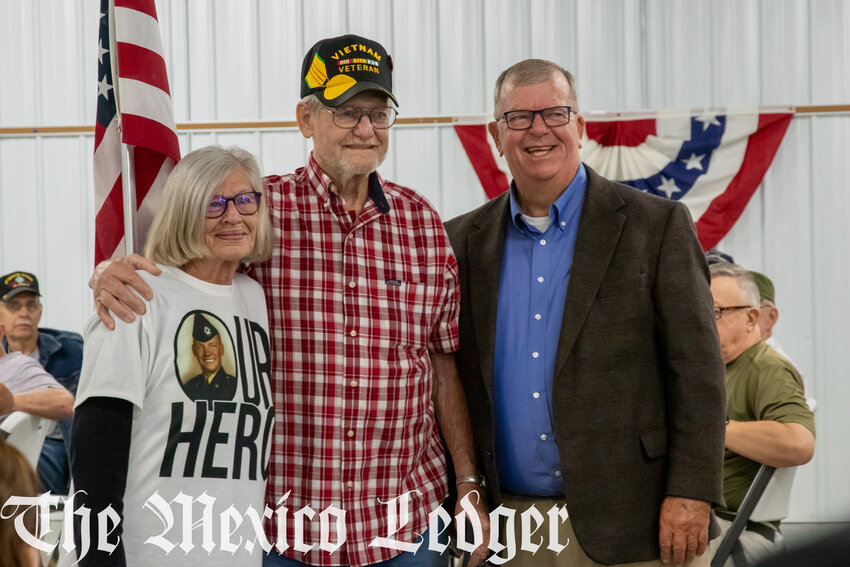 Donna and Robert Gentry pose with state representative Kent Haden. Donna is sporting her honor flight shirt. The back reads, “We can’t all be heroes. Some of us have to stand on the curb and clap as they go by.”