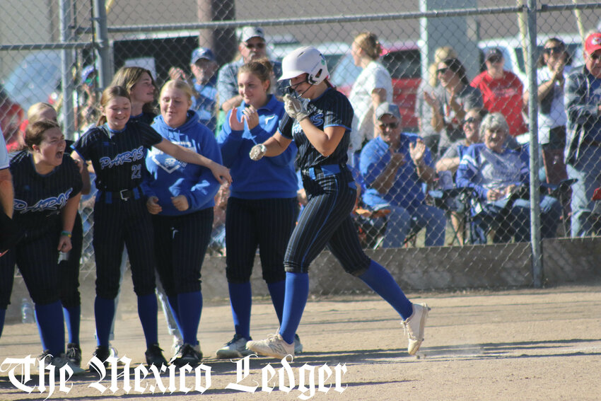 Paris junior Reese Sutton strolls into home plate and a celebration amongst her teammates after hitting the game-winning home run against Clopton on Saturday in the Class 1 District 4 semifinals at Community R-6 in Laddonia.