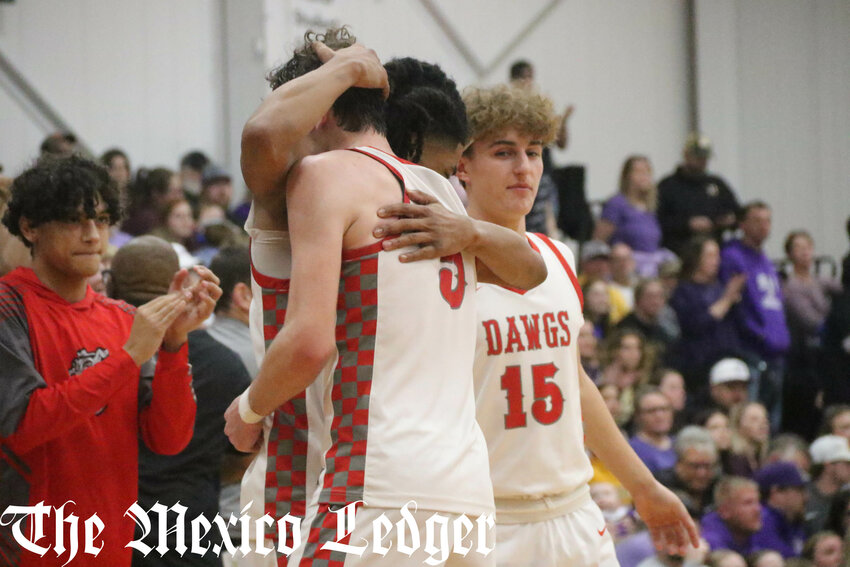 Mexico seniors Jaydon Eldridge (front) and PJ Perkins hug after winning the Class 4 District 8 championship on Friday against Hallsville in Moberly. It was the third district title they won together and the fourth in five years for Mexico.