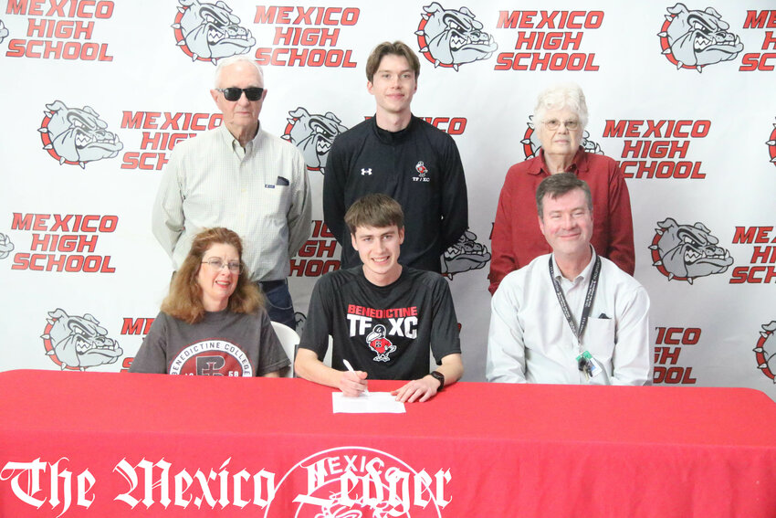 Mexico senior Andrew Peuster is surrounded by his family, including older brother and current Benedictine runner Thomas, on Thursday during his signing ceremony to run cross country and track and field for Benedictine College. Peuster is the second in his family to go from Mexico to the Kansas college for running.