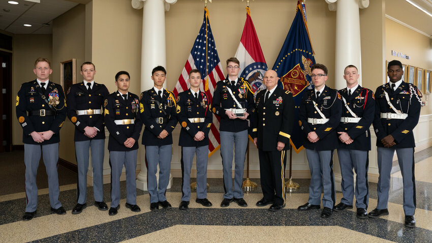 Cadets Duane Thompson, Malachi Imrie, Kyran Carter, Kruze Hagan, Daniel Bravo, Tru Jones, John Trippe, Clayton Reich and Irmuun Ganbat stand with President Richard V. Geraci after earning second place in the High School Division of the Association of Military Colleges and Schools of the United States annual drill competition. Not pictured: Cadet Alvaro Gonzalez.