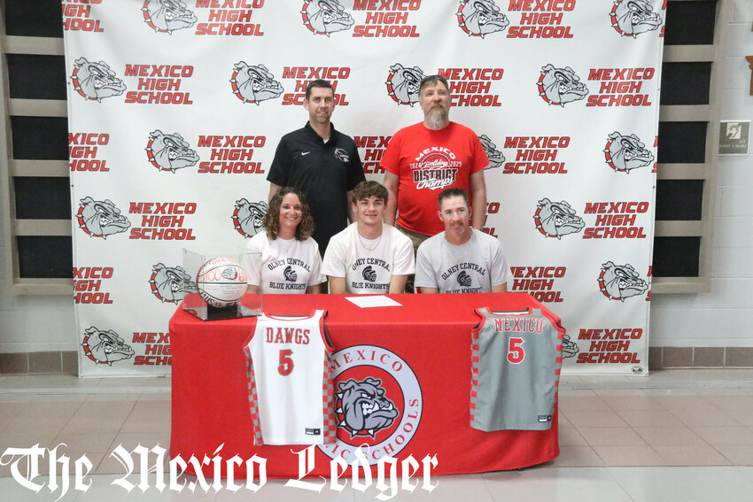 Mexico senior Jaydon Eldridge sits with his parents Whitney and Jeremy Eldridge and gathers with basketball coaches Darren Pappas and Bill Gleeson on May 7 during a signing ceremony at the Mexico Sports Complex to play basketball at Olney Central College in Illinois.