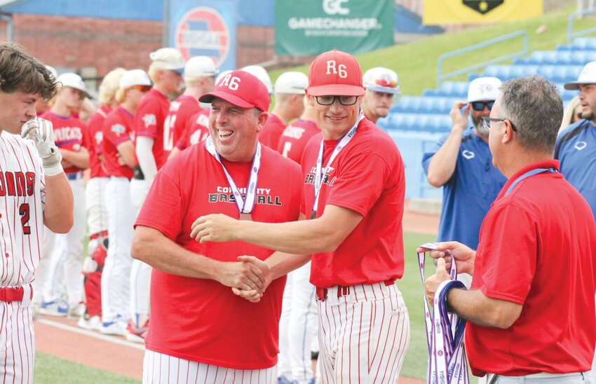 Joel Krato (right), who is leaving his position as the Community R-6 head baseball coach, shakes hands with former assistant Jeff Angel after the Trojans were awarded their medals at the 2023 Class 1 Final Four in Ozark.