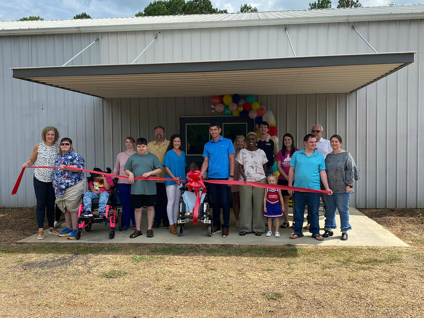 The Refuge of Mississippi recently held a ribbon-cutting ceremony to celebrate their open house. Pictured, from left are Melanie Stevens (Board Member), Andrew Moody, Ashaylin York, Tory Collins (Staff), Anthony Herod, Tim Moore, Brooke Crenshaw, Harlee Crenshaw, and Derek Crenshaw, Deanna Jones (Board Member), Carolyn Ward, Cody Spence (Board President), Lucy and Morgan Jay, Wyatt Sprague, and Paige Walton (Staff).