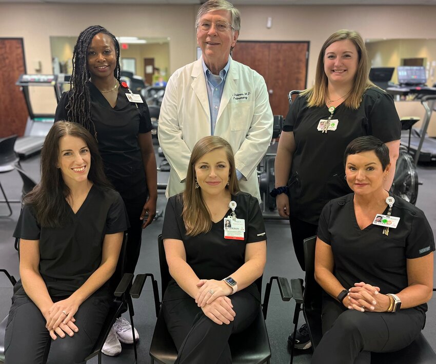 Pictured are, front row from left, Lauren Lagrone, RN; Megan Cain, RN; Regina Haralson, RN (Back)  Laporshia Ruffin, Exercise Physiologist; Dr. Ed Holmes, Pulmonary Medical Director; and Bailey Porter, Exercise Physiologist. Not pictured is Dr. Michael Purvis, Cardiac Medical Director.