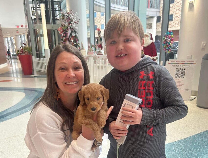 Heart transplant recipient Matthew O’Neal with his mother Stacey and his new puppy, Olaf.