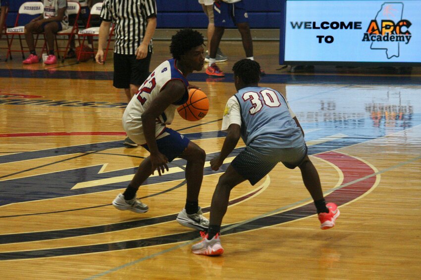 Neshoba Central’s Emanual Moore Jr. looks to dribble past a Choctaw County defender in a Wednesday team camp game hosted by The Church at the Arc.