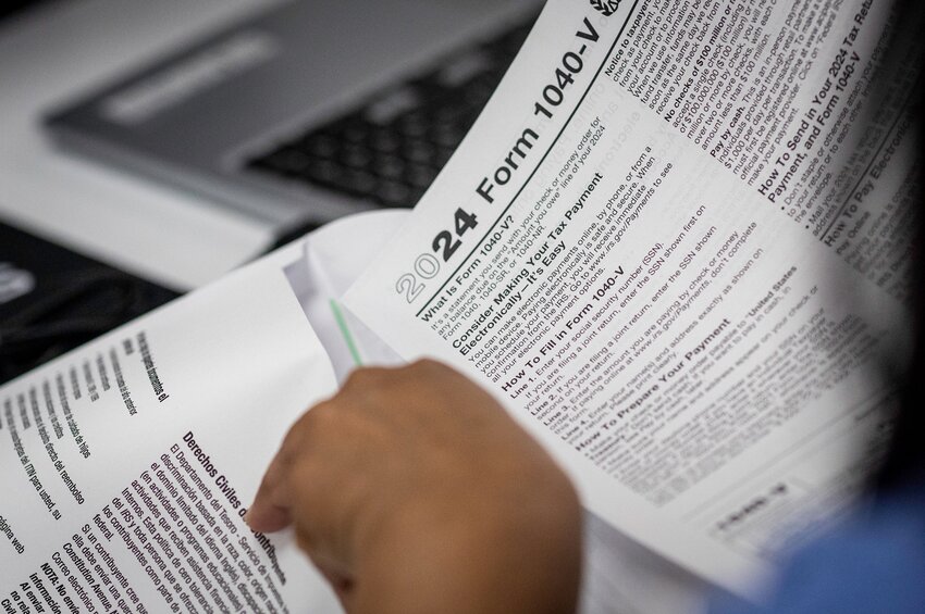 An immigrant receives help in preparing her U.S. income tax forms on March 29, 2025 at an undisclosed location, Connecticut. A nonprofit immigrant center is holding free sessions where tax advisors provide assistance to immigrants in preparing their tax documents. Many immigrants, including legal green card holders, have expressed extreme anxiety as the Trump administration enacts more stringent immigration policies, including mass deportations of undocumented people living in the United States.