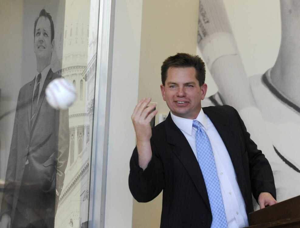 Rex Rust, co-president of Rust Communications, tosses the ball to his brother, Gary II, during the dedication and open house of Southeast Missouri State University's new Rust Center for Media on Oct. 7, 2016. (File photo / Southeast Missourian)