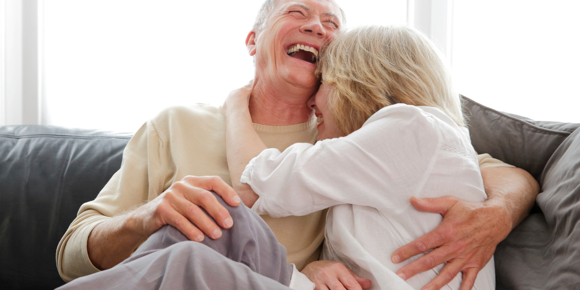 Mature couple laughing and cuddling.