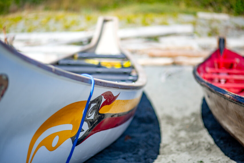 Canoes lined up on the beach at Fort Worden July 26 as S'klallam tribes gathered for their annual paddle event.