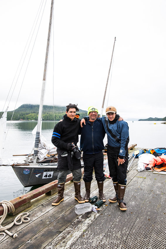 Greg Veitenhans and his sons Henry (left) and Joey (right) stand by the boat they rowed and raced as part of the Race to Alaska in 2019.
