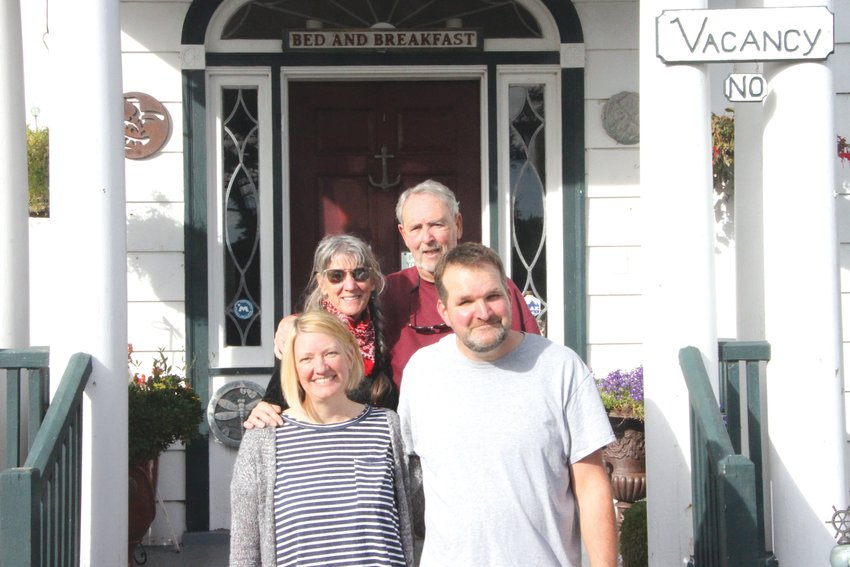 Natalie Dionne, Gail Oldroyd, Jim Oldroyd and David Dionne stand at the front steps to the Commander&rsquo;s Beach House, a bed-and-breakfast located on the water at Point Hudson.