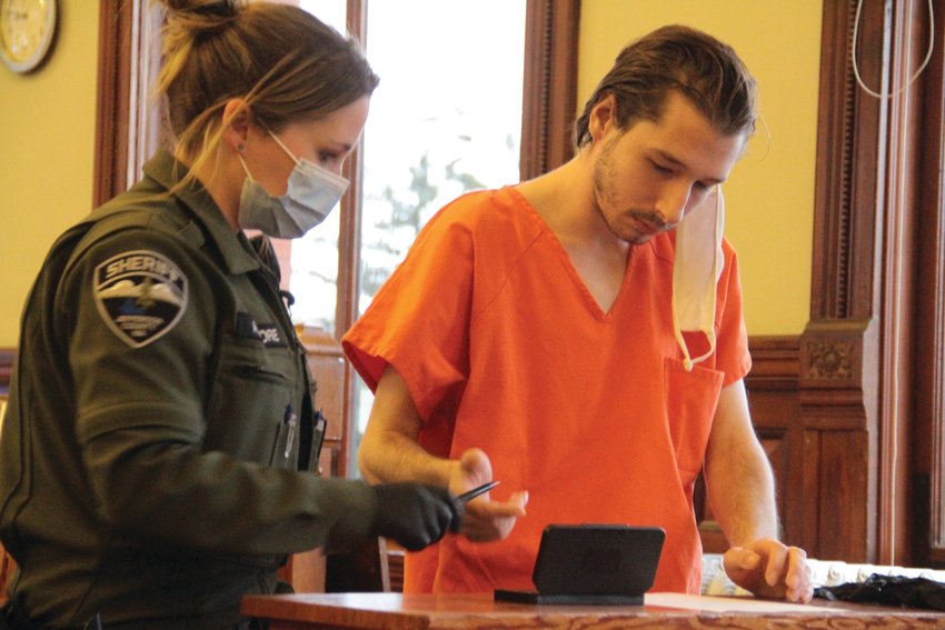 Spencer Aaron Schenk is handed a pen to sign his fingerprint card after his conviction Friday in Jefferson County Supeior Court for the Thanksgiving morning burglary at Fat Smitty&rsquo;s.