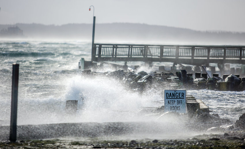 Waves crash over the Point Hudson jetty during a wind storm that coincided with a king tide on Dec. 20, 2018.