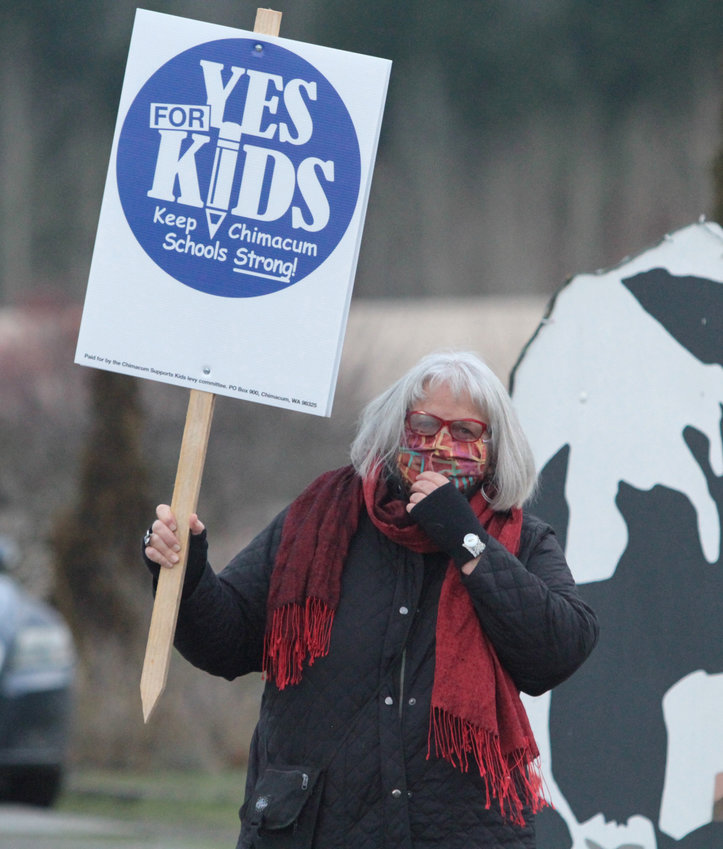 Chimacum School Board Chair Kristina Mayer waves a sign in support of the district&rsquo;s replacement levy on next week&rsquo;s special election ballot during a rally by supporters at the Chimacum Corner Farmstand.