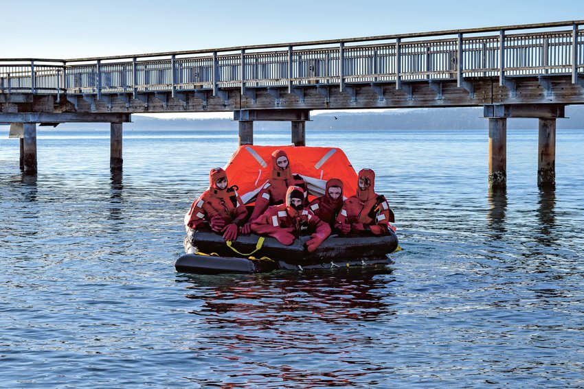 Port Townsend Maritime Academy students familiarize themselves with immersion suits and a life raft. Students who enroll in the new Maritime High School will have the chance to engage in similar project-based learning opportunities.