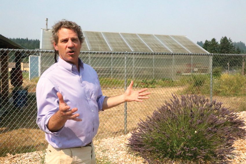 Superintendent Scott Mauk stands in front of one of the school&rsquo;s greenhouses. All meals served at Chimacum schools are cooked from scratch and include produce grown on site.