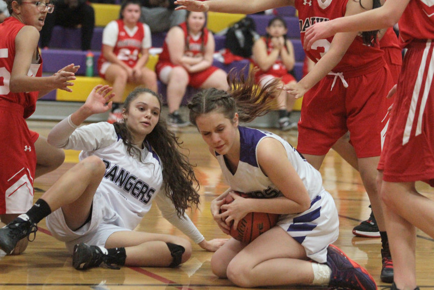 Quilcene's Kaydence Yeoman comes up with the ball during a scramble while Shelby Love looks on.