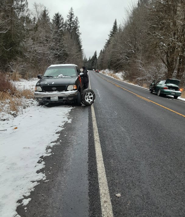 Alex Apodaca was driving his Ford pickup home to Brinnon from Discovery Bay when got a flat tire, and was hit by an unknown motorist. This photo was taken Tuesday, Dec. 27 as family worked to replaced the tire.