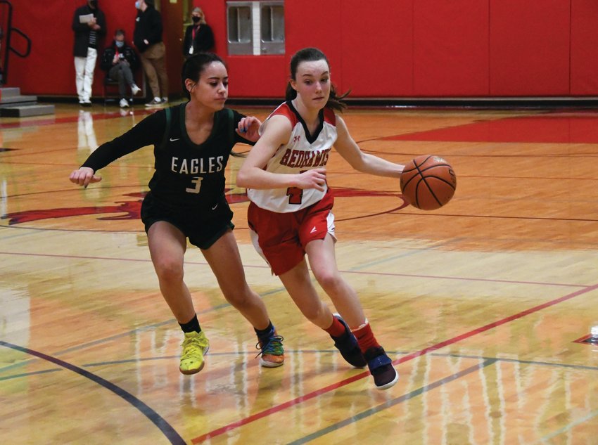 Point guard Kay Botkin dribbles past a defender on her way to the basket.