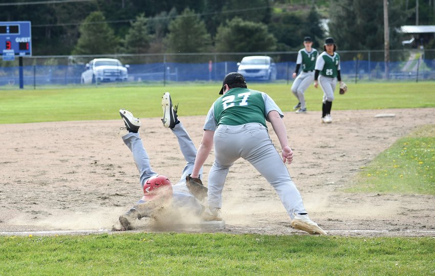 Nathan Nisbet of the Rivals ends up in a scorpion pose after successfully sliding into third base early in the game.