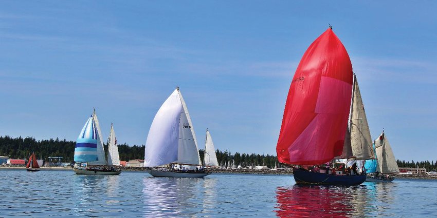 Sailboats cruise Port Townsend Bay during a previous Classic Mariner&rsquo;s Regatta.