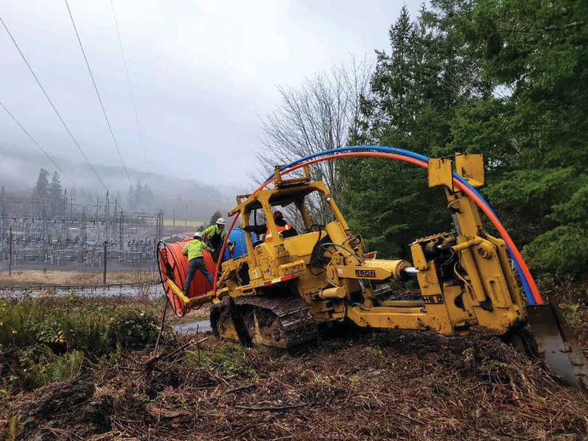 A work crew installs an underground fiber optic line in Jefferson County.