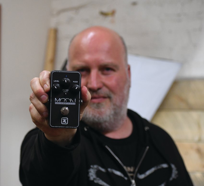 James Schultz of The Guitar Store in Port Townsend poses with the top-selling Keeley Electronics Moon Op Amp Fuzz Pedal, which he helped design and create.