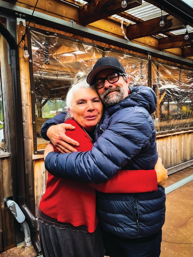 Coco Huin, who previously owned the crepe camper with her husband Olivier, embraces new owner Brian Stafford as she passes the business along to him and his son.