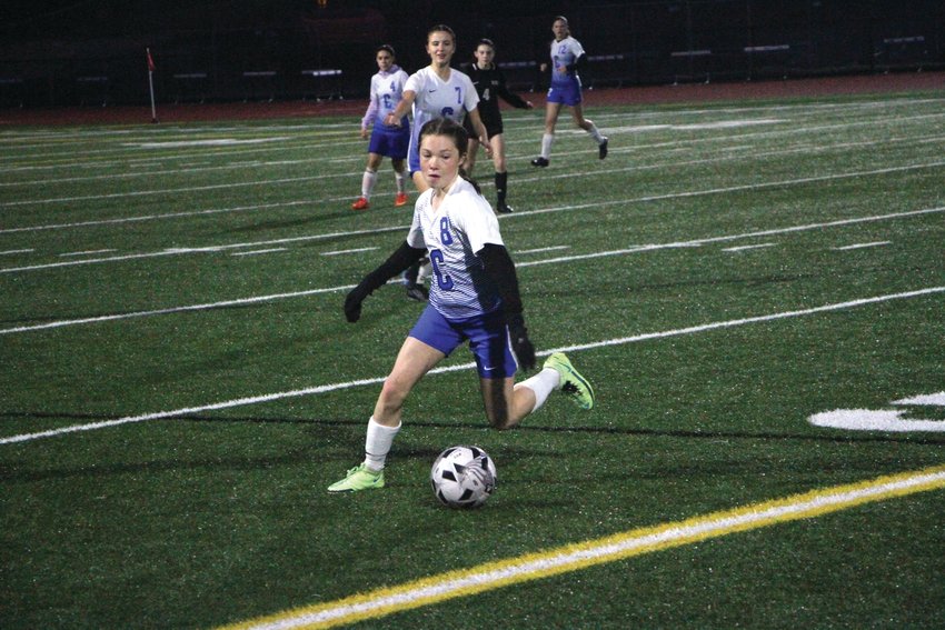 Rising junior midfielder Ava Shiflett dribbles onward in an away matchup against Klahowya Secondary School last year. Shiflett was a crucial part of EJ&rsquo;s potent offense last year, linking passes from the backfield to Rivals scorers.