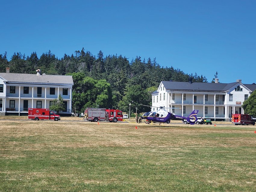 An Airlift Northwest helicopter takes off from the parade grounds at Fort Worden to shuttle an injured walker to Harborview Medical Center in Seattle.