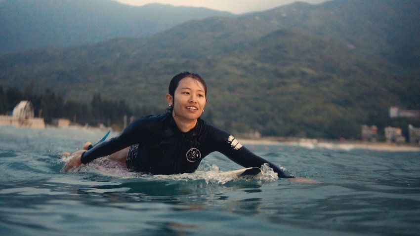 Lolo, one of the central characters of the documentary, rides out to catch a wave in China&rsquo;s Hainan province, known for its tropical beach environment.