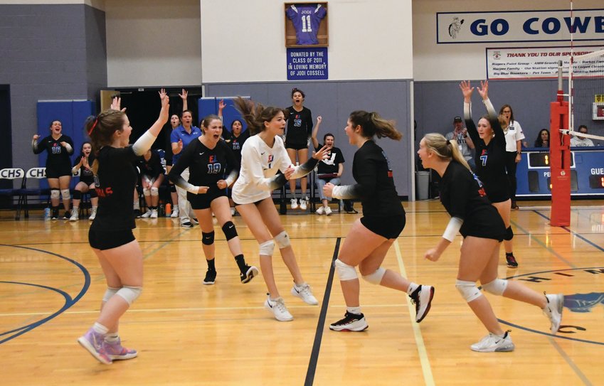 EJ&rsquo;s varsity lineup celebrates after scoring a point during the second set of the matchup
