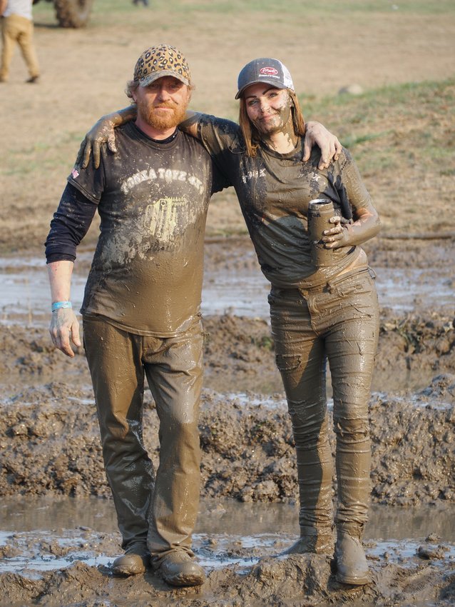 Tonka Toyz 4x4 Club vice president Jeremy Coburn shares a mud-covered moment with Krystal Brilhante in between races.