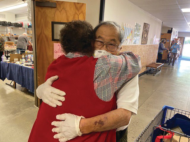 Volunteer David More hugs a shopper on a recent Senior Saturday at Port Townsend Food Bank.