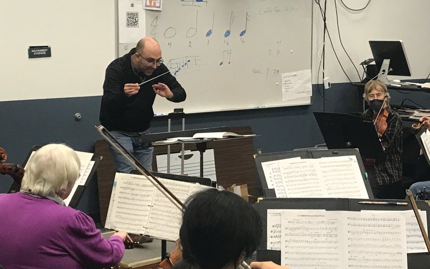 Port Townsend Symphony Orchestra Conductor Tigran Arakelyan leads the musicians during a recent rehearsal.