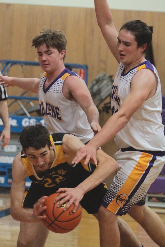 Mason Iverson and Hunter Simmons put the pressure on Clallam Bay&rsquo;s William Hull during the Bruins&rsquo; matchup against the Rangers.