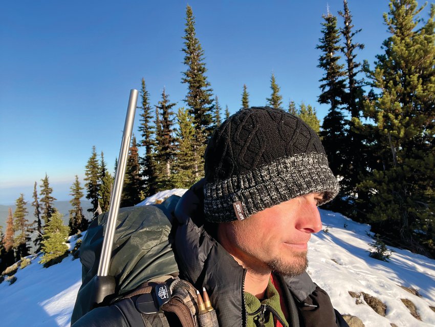 Local hunter Kris Heyting hikes the backcountry with a specialized lightweight rifle to ease the load he has to carry up the slopes.