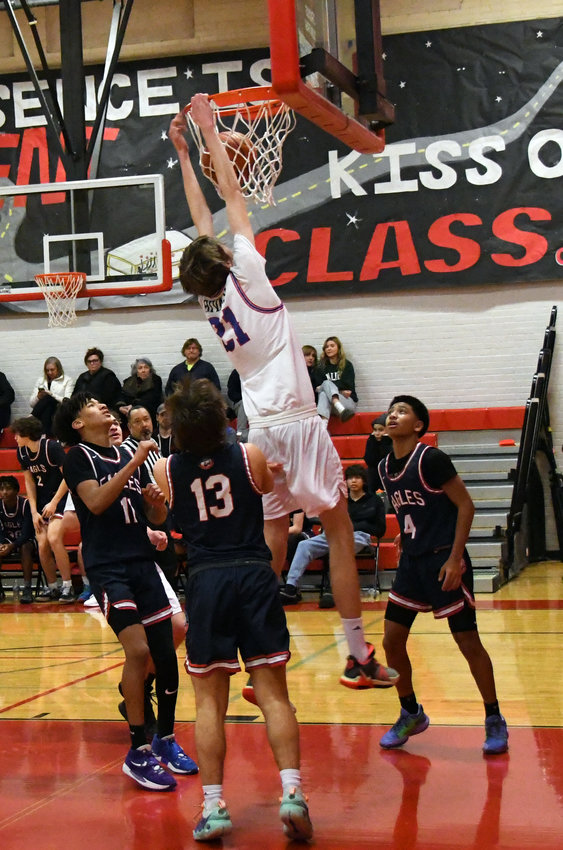 Rivals junior Stuart Dow slams down a putback dunk, inspiring a wave of momentum and a roaring crowd in the first half.