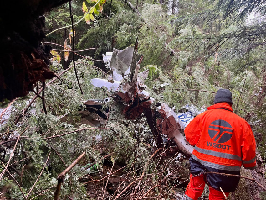 A search-and-rescue crew member approaches the wreckage of a 2006 Cessna T182 Turbo Skylane that went missing in early March.