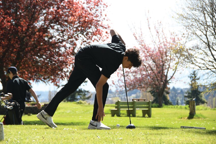 EJ freshman Ryan Olson readies his ball before teeing off on Hole 1 at the Port Townsend Golf Course.