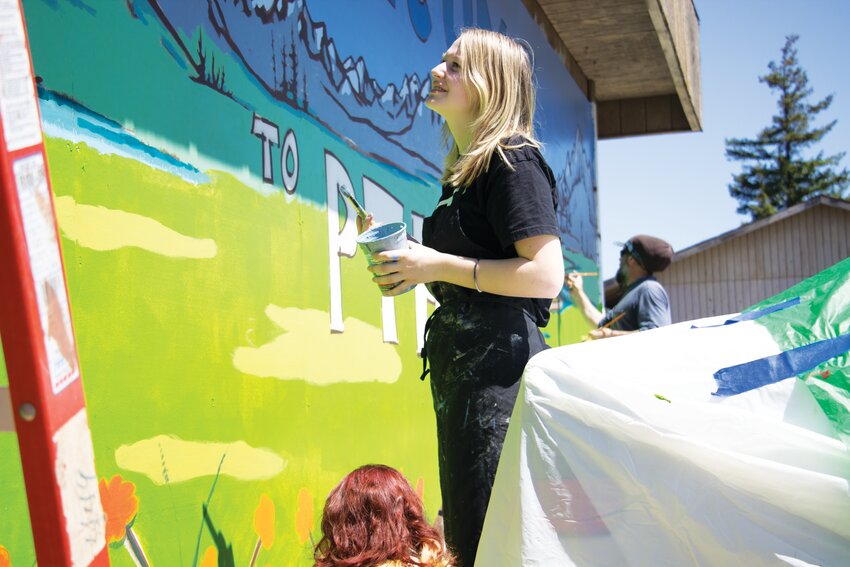 Tenth-grader Makayla Matheson works on the mountain portion of the mural.
