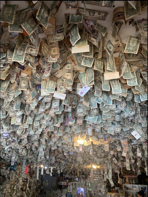 Dollar bills hang on the walls and ceiling of Fat Smitty&rsquo;s.