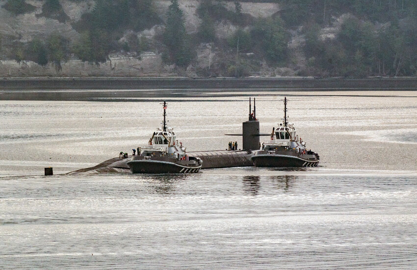 A US Navy ballistic missle submarine is escorted into Port Townend Bay early Monday morning excorted by a Marine Security Vessel and a Navy tug and later moored at Naval Magazine Indian Island.