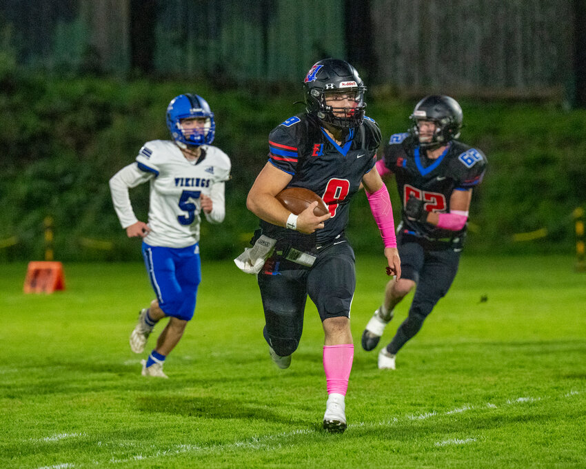 Rivals quarterback, Aaaron Glanz races to the first down marker during a game against the Bellevue Christian Vikings played Saturday night in Port Townsend&rsquo;s Memorial Field.