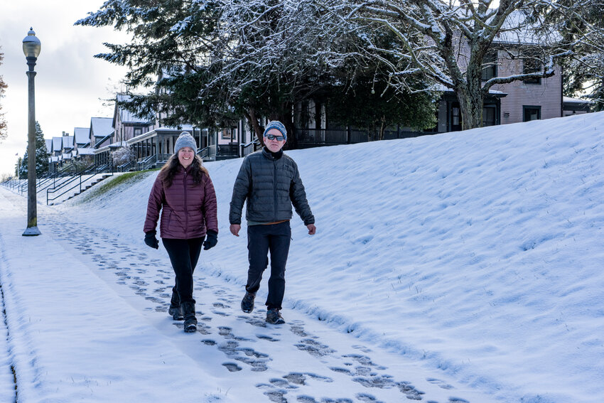 Nelin Swayze and Josh Porter, both from Port Townsend, enjoy a stroll in the snow at Fort Worden State Park on Tuesday morning. An overnight snow storm deposited about three inches of the fluffy stuff. Photo by Steve Mullensky for The Leader