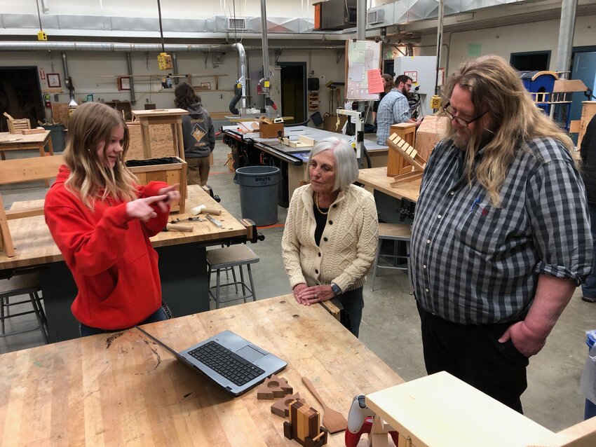 Eleventh-grader Sitka Vicha describes her project to Kathryn Lamka and history and journalism teacher Brian MacKenzie. On March 13, members of the Chimacum School Board toured the shop and learned about the Chimacum Schools Construction Trades Program. Courtesy photo