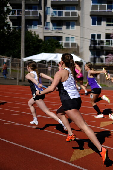 A relay exchange between EJ runners Audrey Matthes and Kaida Rodrigues in the girls 4x100-meter relay.