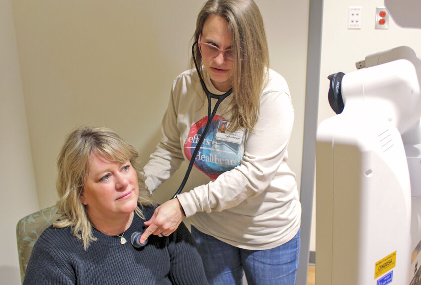 Director of Clinical Operations Kadie Randel (seated) demonstrates the patient experience for tele-rheumatology and tele-neurology. Practice Manager Lindsay Dykes demonstrates the medical assistant&rsquo;s role during these appointments.